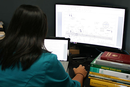 An engineer reviewing testing plans on a computer
